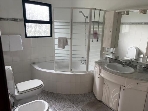 a bathroom with a tub and a toilet and a sink at Mountain retreat in Boaventura