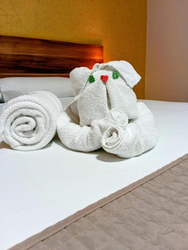 a towel animal is sitting on a bed at Beira Lago Palace Hotel in Morrinhos