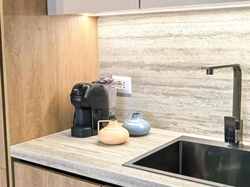 a coffee maker sitting on a counter next to a sink at Downtown Shkodra Apartment in Shkodër