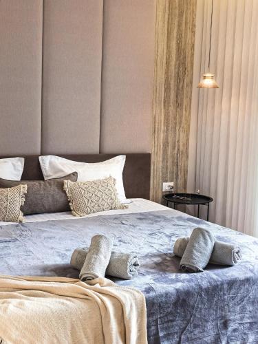 a bed with two pillows on top of it at Downtown Shkodra Apartment in Shkodër