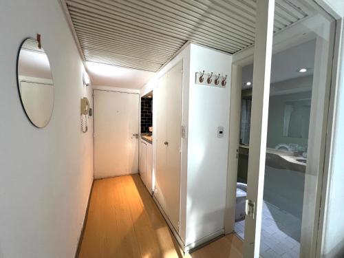 a room with a hallway with a mirror and a bathroom at Apart hotel Ciudad de Bs As in Buenos Aires