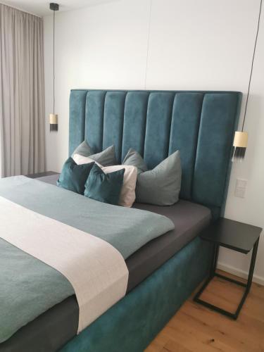 a bedroom with a large bed with a blue headboard at Fewo Ostseeparadies Meerblick in Graal-Müritz