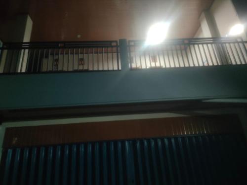 a staircase in a building with a light on it at Udayana Bisma in Singaraja