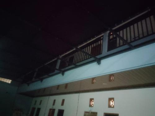 a building with a balcony on the side of it at Udayana Bisma in Singaraja