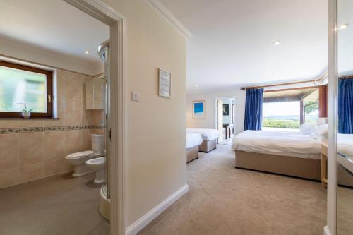 a bedroom with two beds and a tub and a toilet at lakeside Estate in Bristol