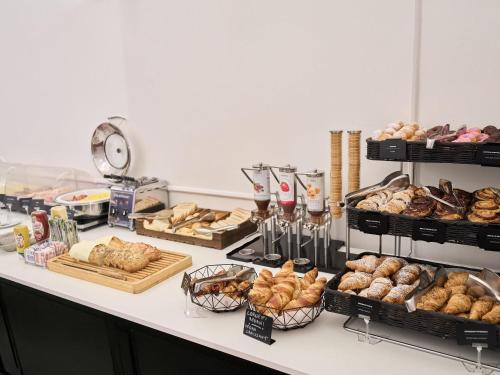 a bakery counter with various types of bread and pastries at B&B Hotel Napoli in Naples