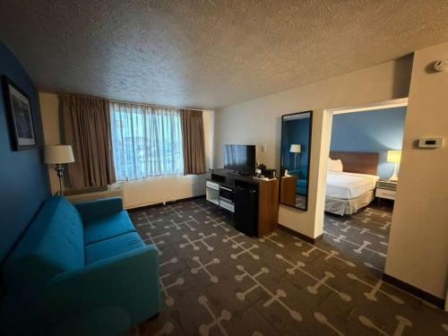 a hotel room with a bed and a blue couch at Spokane Boutique Hotel in Spokane