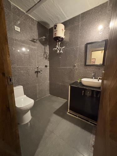 a bathroom with a toilet and a sink at Aranyaa Cottage Homestay Vrindavan in Jait