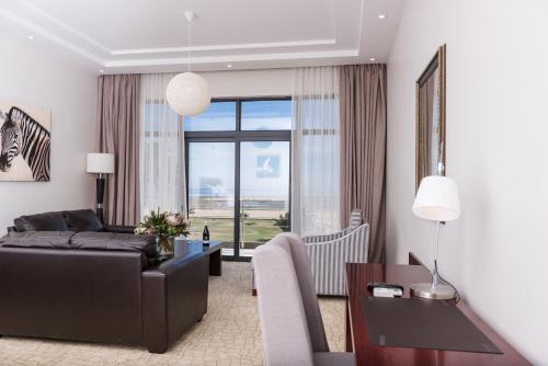 a living room with a couch and a table at Flamingo Villas Boutique Hotel in Walvis Bay