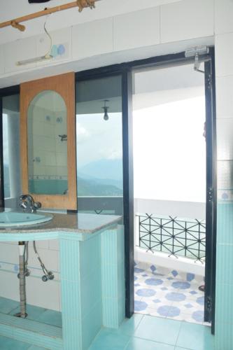 a bathroom with a sink and a mirror at Hotel Hari mangalam heritage in Tehri-Garhwāl