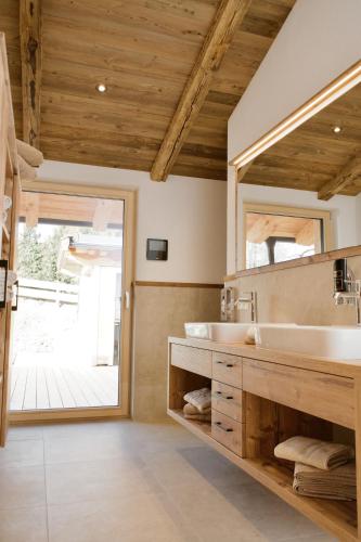 a bathroom with a large mirror and a sink at Chalet Schernthann in Salvenberg