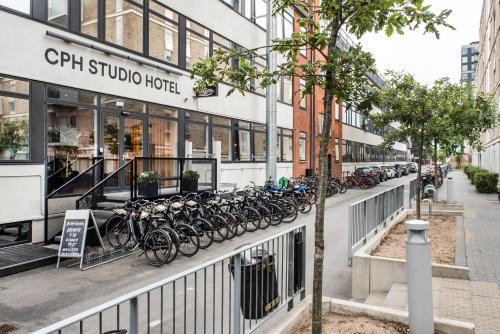 a row of bikes parked in front of a building at CPH Studio Hotel in Copenhagen