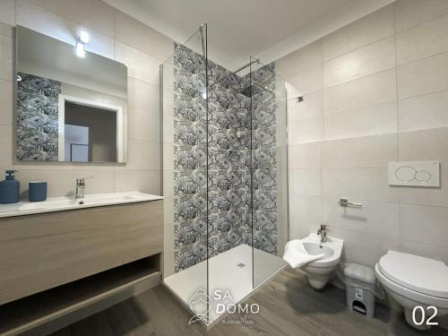 a bathroom with a toilet and a sink at Sa Domo de nonna Maria in Ottava Sassari