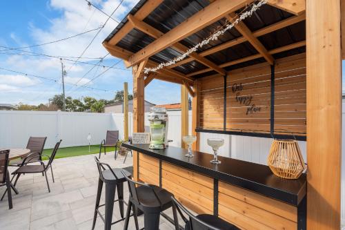 a patio with a bar with chairs and tables at Luxury Vacation Home in Madeira Beach Family and Pet Friendly in Seminole