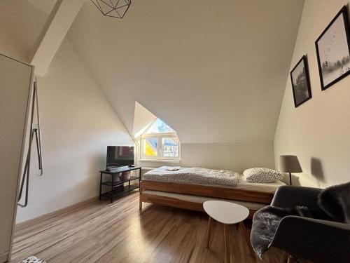 a bedroom with a bed and a window at Apartmány u Klínovce in Vejprty