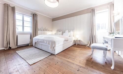 a white bedroom with a white bed and a desk at Villa Stella all famous ski areas around us, 15 minutes to salzburg, mountainview in Golling an der Salzach