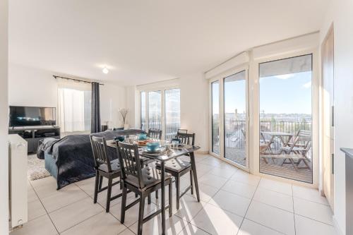 a living room with a bed and a table and chairs at Dumbo - Île de Nantes in Nantes