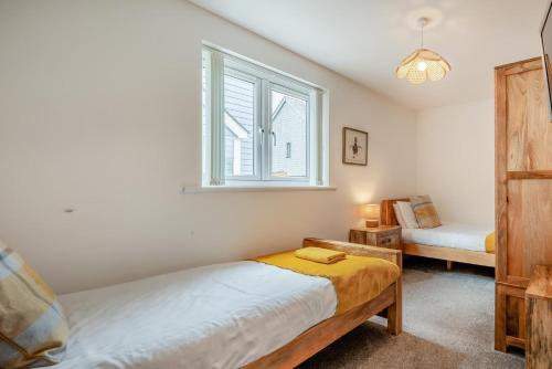 a bedroom with a bed and a window at 2 Bed in St. Issey oc-o27778 in Saint Issey