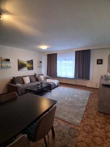 a living room with a couch and a table at Ferienwohnung Lina in Nistertal