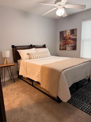 a bedroom with a bed and a ceiling fan at Chic City Apartment with parking Canal View RoofDeck in Indianapolis