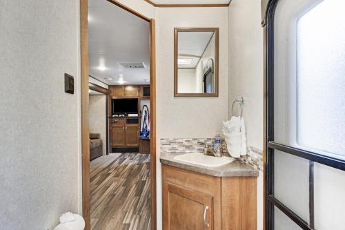 a bathroom with a sink and a mirror at Perfect camper for your vacation in Ellenton