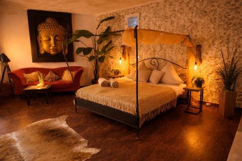 a bedroom with a canopy bed with a statue of a head at Ferienwohnung Time out in Vreden