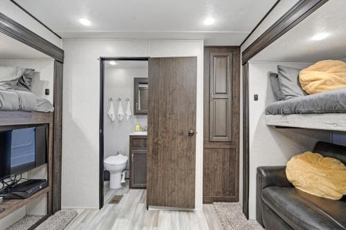 a small room with two bunk beds and a bathroom at Roam sweet roam in Ellenton