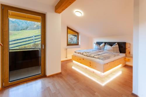 a bedroom with a bed and a large window at Mountain Apex in Dölsach