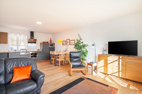 a living room with a couch and a dining room at Kira in Börzow