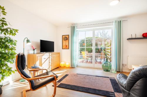 a living room with a chair and a television at Kira in Börzow
