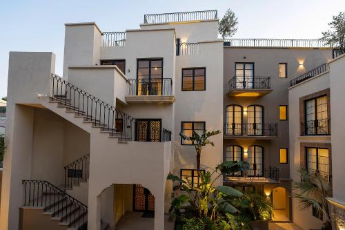 a white building with stairs in front of it at Paseo del Centro, Condominio Boutique in San Miguel de Allende