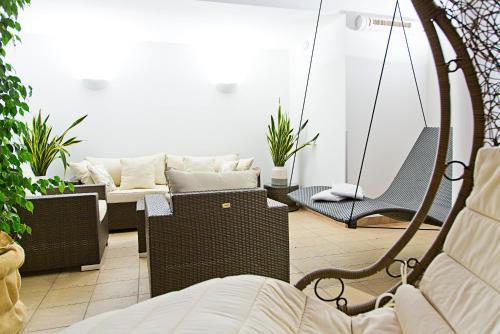 a living room with a couch and chairs at Hotel in the HEART of the Alps in Uttendorf