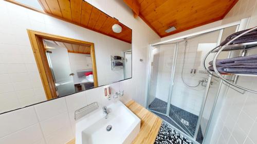 a bathroom with a sink and a glass shower at Moving Rooms in Wimpassing