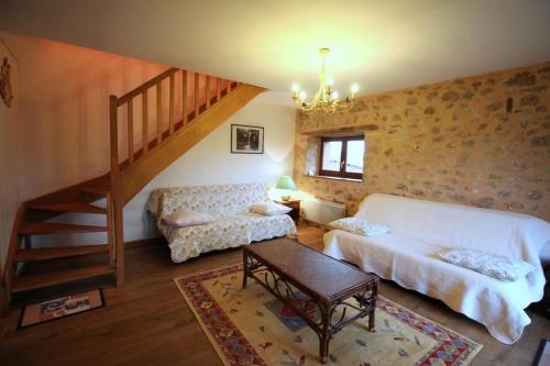a living room with a staircase and a white couch at Leygat in Solignac