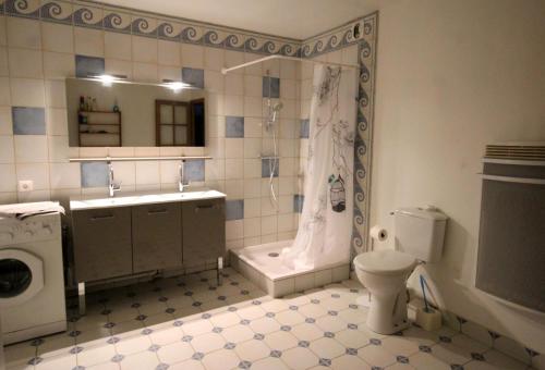 a bathroom with a sink toilet and a shower at Leygat in Solignac
