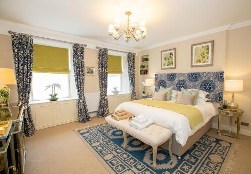 a bedroom with a bed and a chandelier at 7 Howard Place in St. Andrews