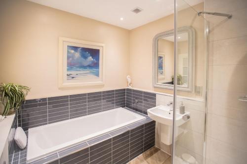 a bathroom with a bath tub and a sink at 7 Howard Place in St. Andrews