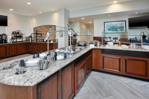a kitchen with a counter with plates on it at Staybridge Suites Lincoln North East by IHG in Lincoln