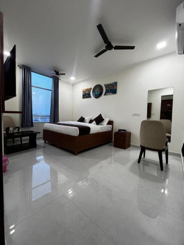 a bedroom with a bed and a ceiling fan at Mayura palace in Jaipur