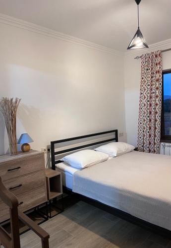 a bedroom with two beds and a dresser and a window at Green Agarak Guest House near Dendropark, Stepanavan in Gyulagarak