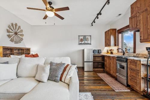 a living room with a couch and a ceiling fan at Bliss Retreat in Whitefish