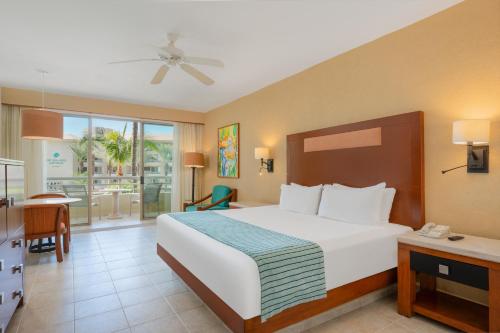 a hotel room with a bed and a dining room at GR Solaris Lighthouse - All Inclusive in San José del Cabo