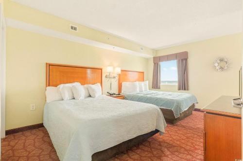 a hotel room with two beds and a window at Bay View Resort 1202 in Myrtle Beach