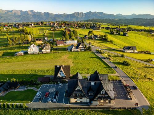 an aerial view of a farm with mountains in the background at Willa Bustryk in Bustryk
