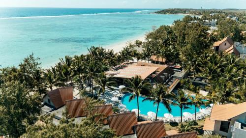 an aerial view of a resort with a swimming pool and the beach at Crystals Beach Resort Belle Mare, a member of Radisson Individuals in Belle Mare
