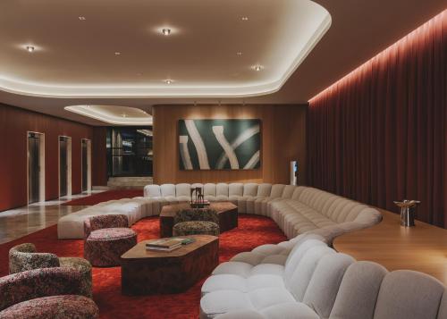 a living room with a large couch and chairs at Catalonia Boulevard 4 Sup in Barcelona