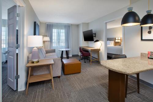 a hotel suite with a living room and a bedroom at Staybridge Suites Lincoln North East by IHG in Lincoln