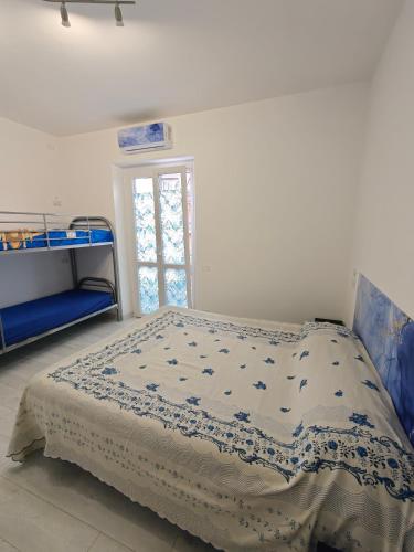 a bed in a white room with a window at La Rosa di Orvieto in Orvieto