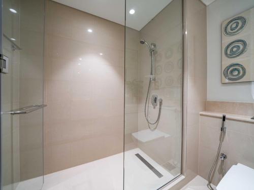a shower with a glass door in a bathroom at Stunning One bed Dubai mall downtown in Dubai