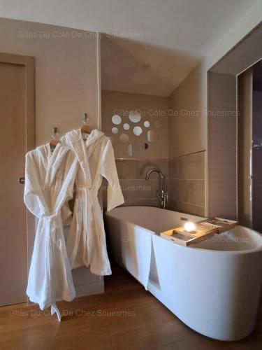 a large bath tub in a bathroom with a mirror at Gîte Du Côté de Chez Souesmes in Souesmes